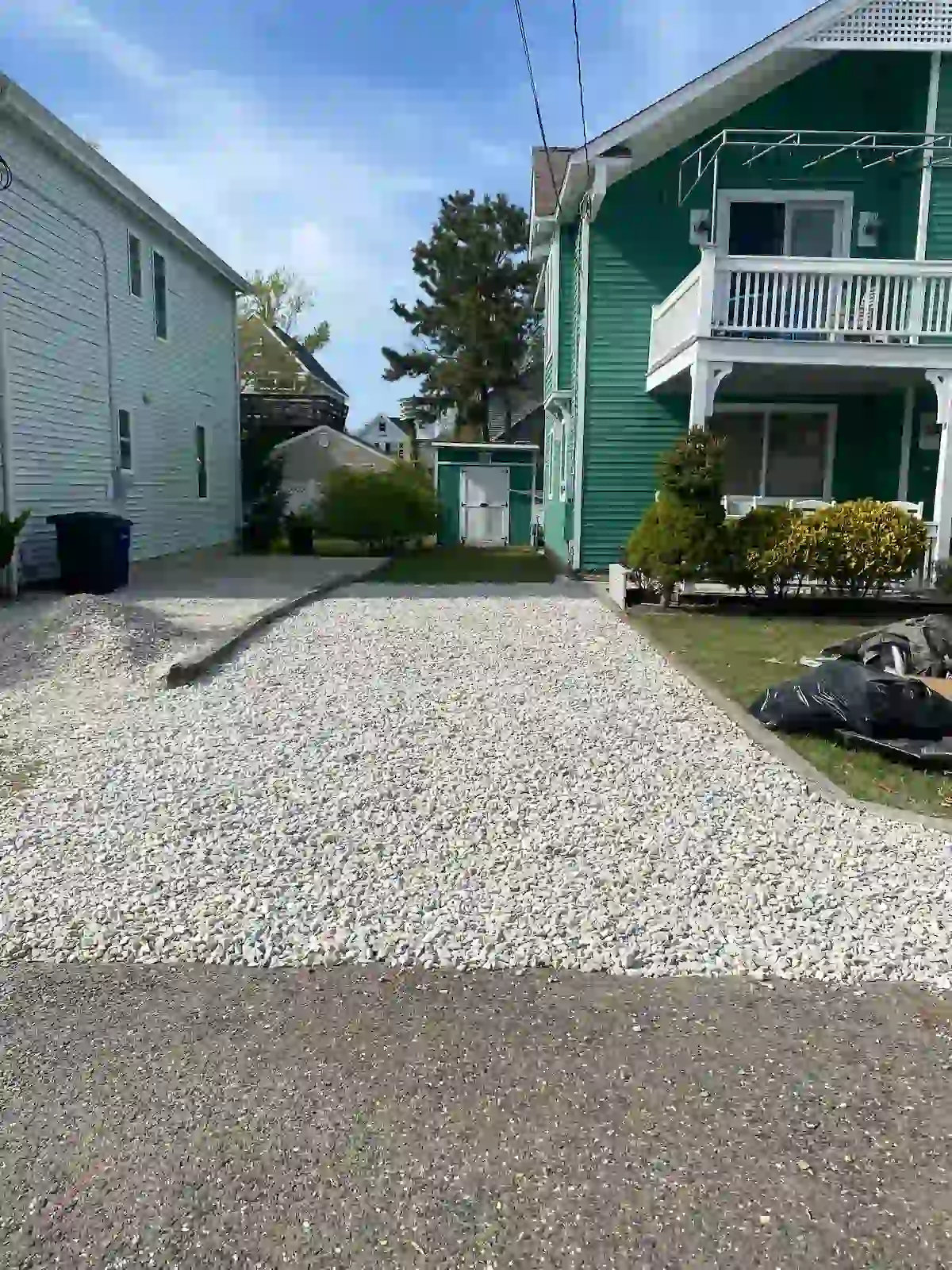 Renovated gravel driveway with clean borders and upgraded stone surfacing for a smoother, refreshed look.