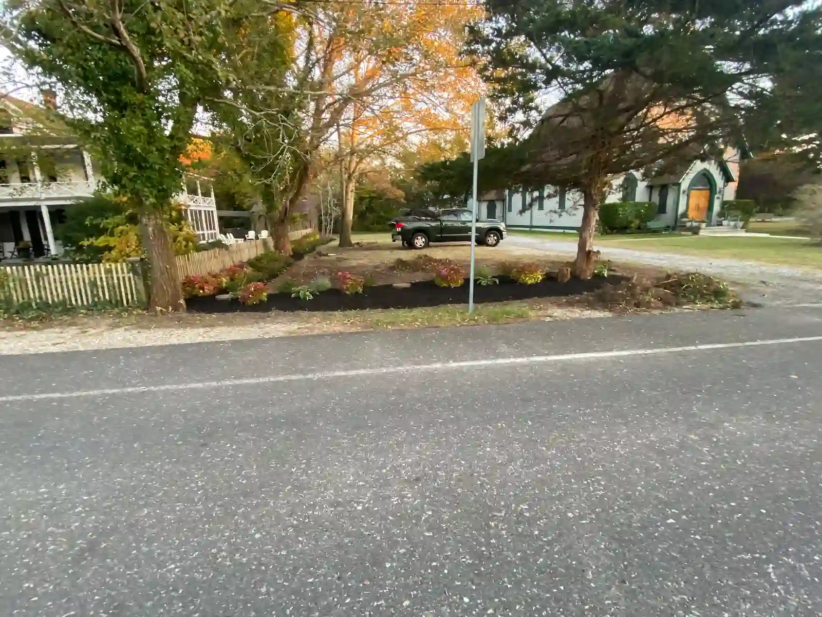 Freshly mulched landscape bed with shrubs and clean edges installed by Green Harmony Landscaping in South Jersey.